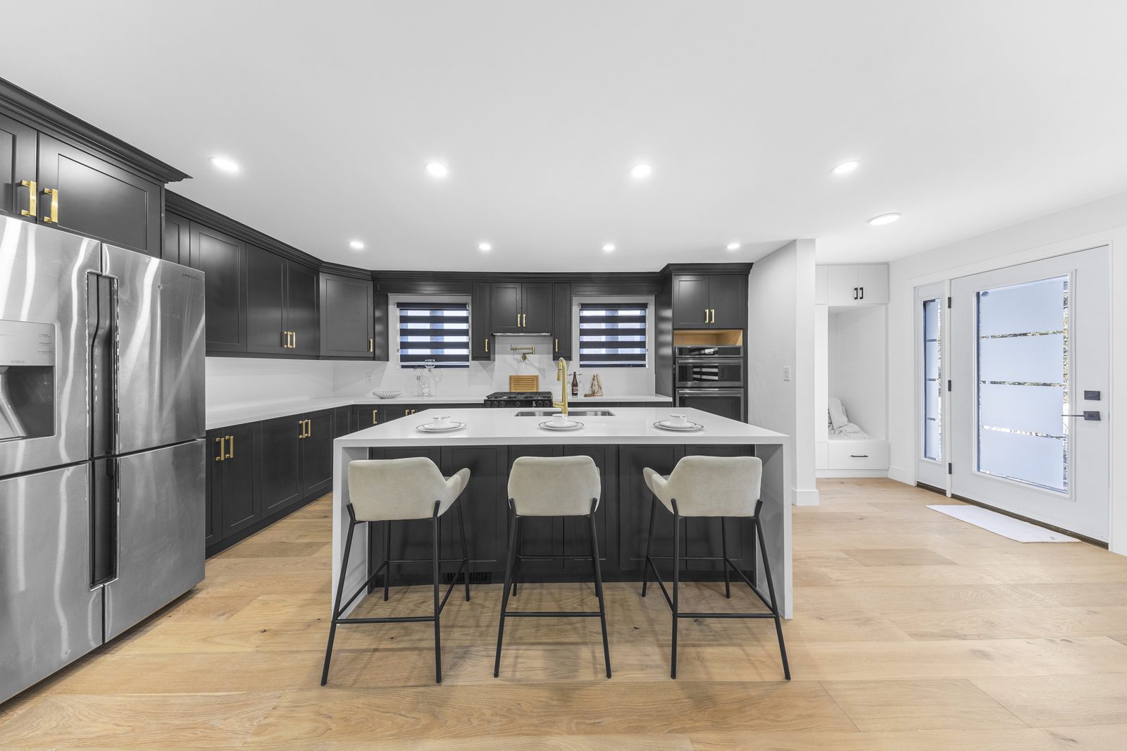 Kitchen with dark cabinetry and brass hardware