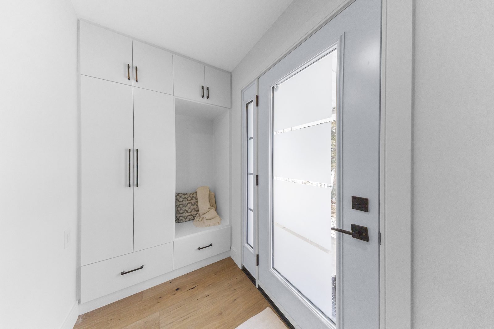 Mudroom with built-in storage and bench